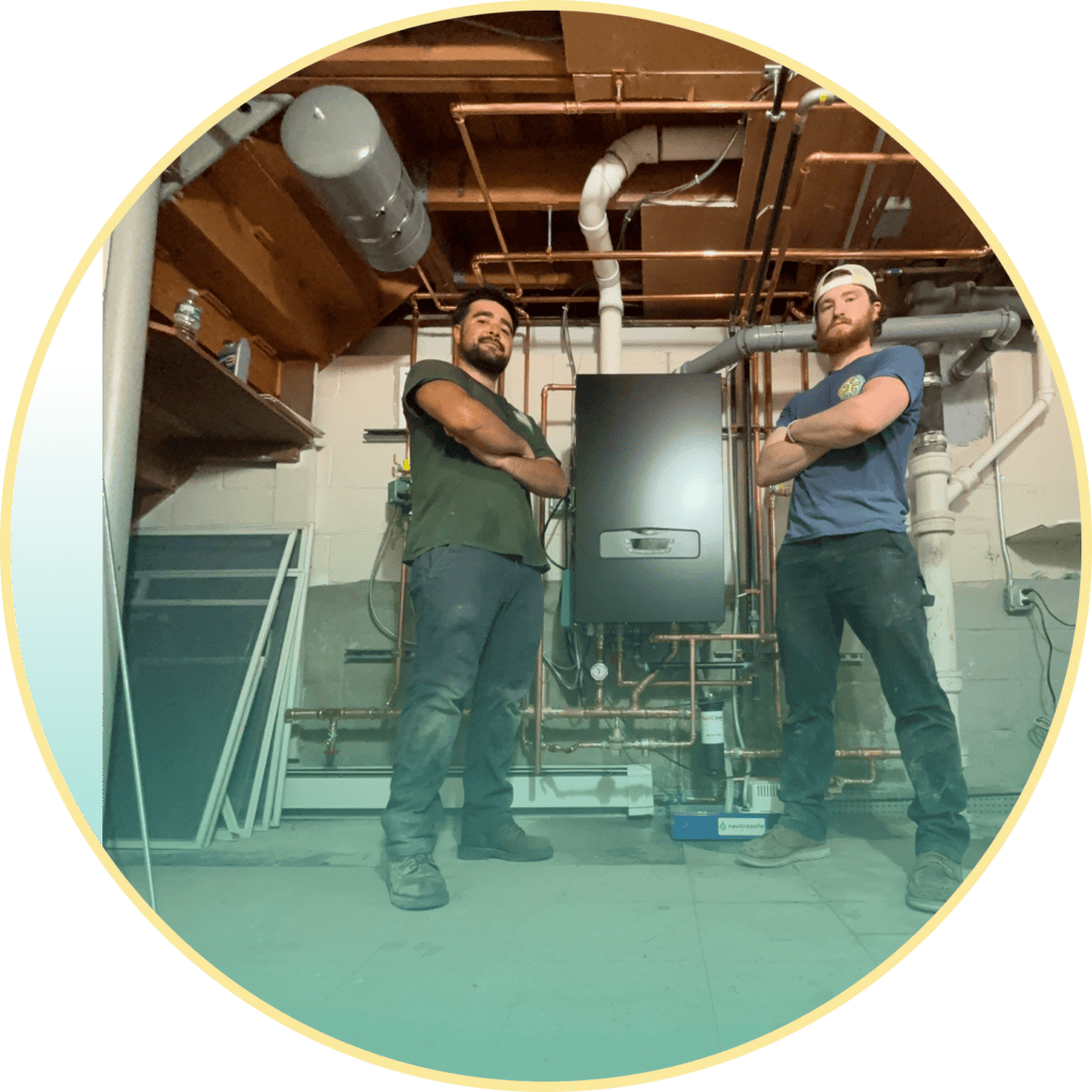 Sustainable Heating & Cooling installation crew proud of their work after installing a boiler.